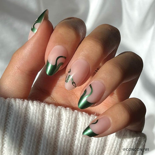 Hand with green and pink nail design on a white background