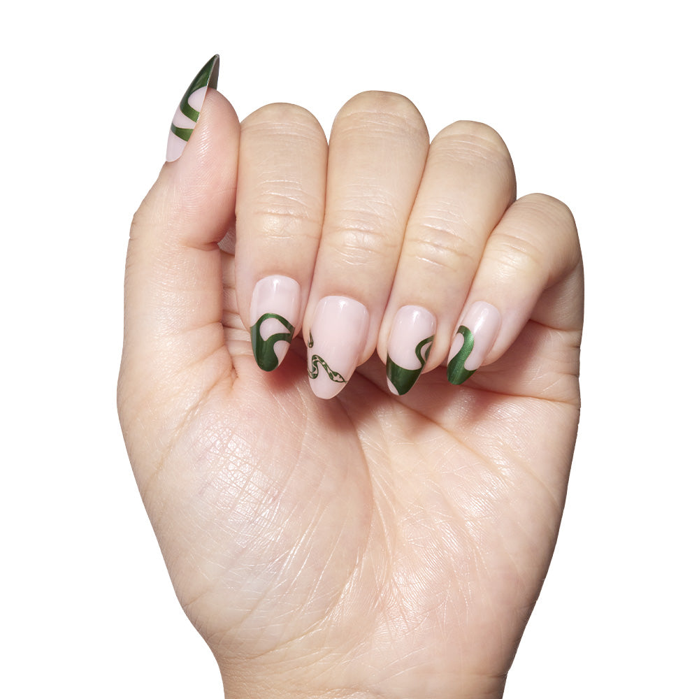 Hand with green and white nail art on a white background