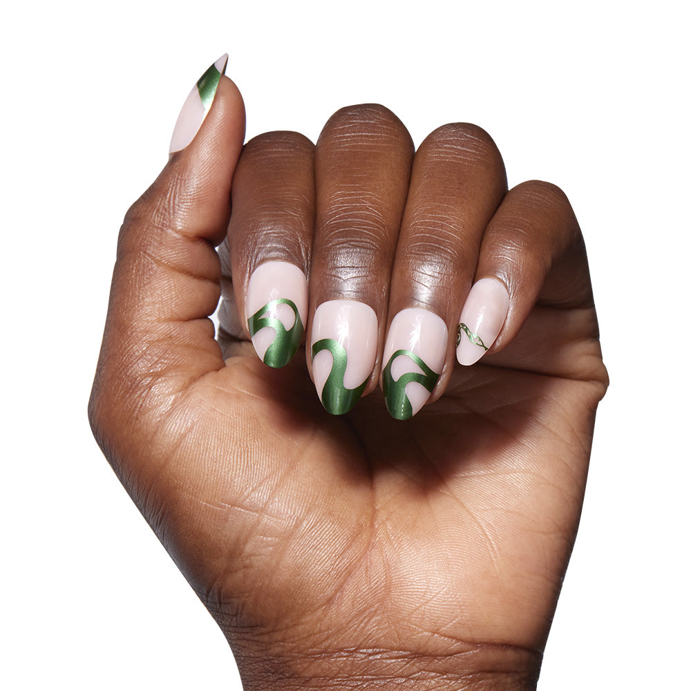 Hand with green and white nail design on a white background