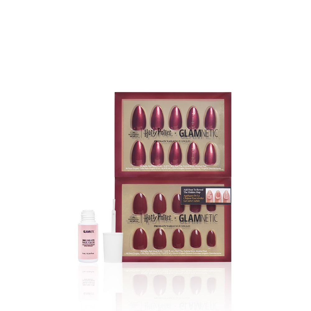 Harry Potter Glamnetic nail art set with red nail shapes and a brush-on nail glue bottle on a white background